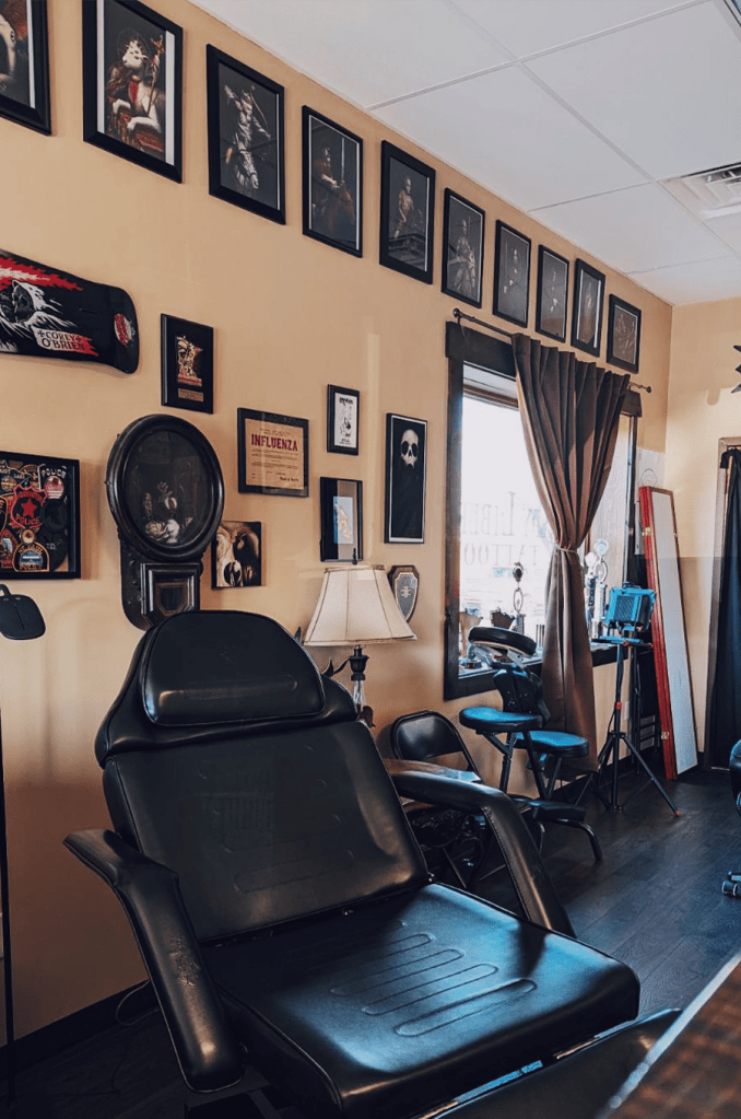 Inside our shop at Lady Liberty Tattoo - comfortable chairs and plenty of artwork for you to look at while clients sit back